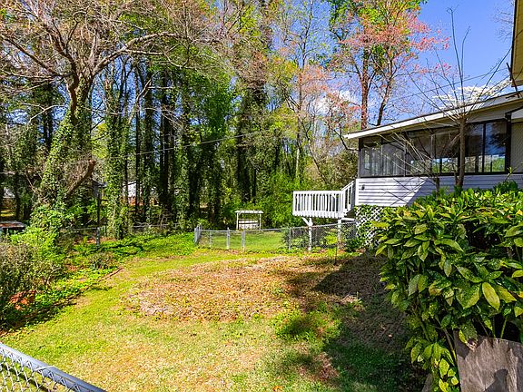 View of backyard and the enclosed sunroom