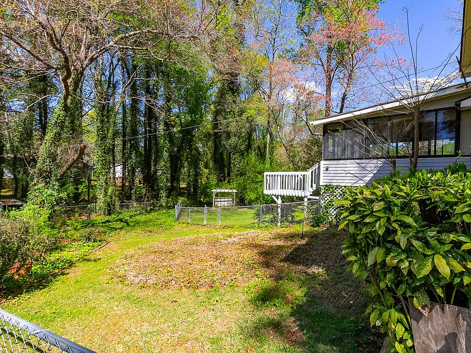 View of backyard and the enclosed sunroom