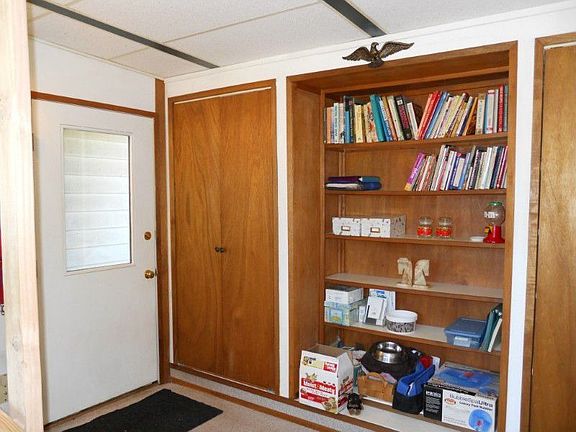 Exterior entrance into a bonus room which features 2 closets plus built in bookshelves.