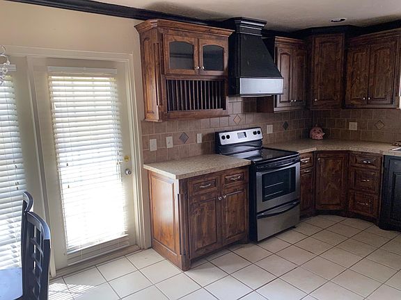 Entrance to kitchen. Frenc door to patio and fenced yard. Upgraded cabinets with self closing drawers, pull out drawers.