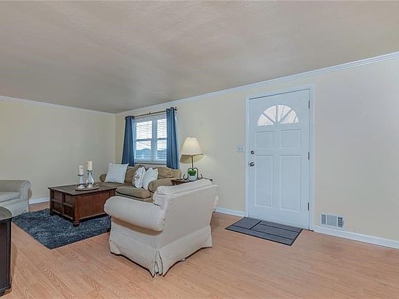 Expansive living room with neutral decor and maintenance free flooring