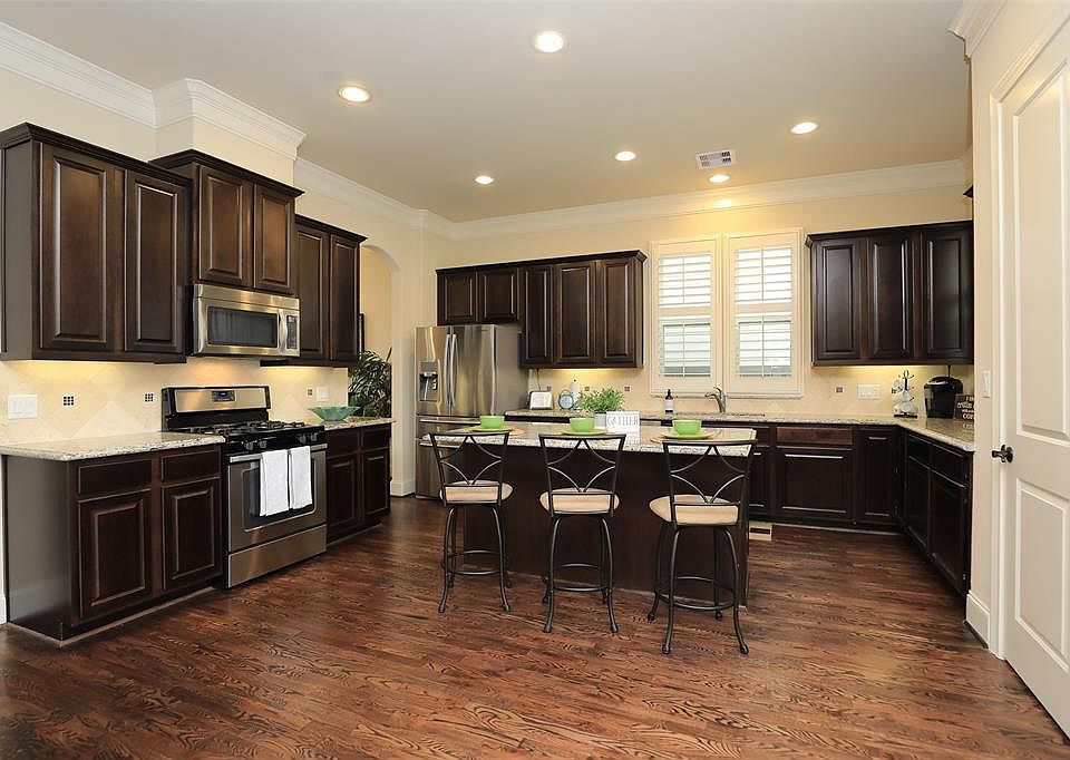 WELCOME HOME to 8712 Kempwood Manor! This open-concept kitchen is a FABULOUS space for entertaining! The cabinets are 42" so there is so much space for storage. The door on the right side goes to the pantry.