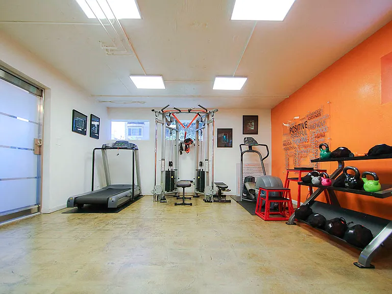 On-site gym with treadmill, weight machines, and free weights.