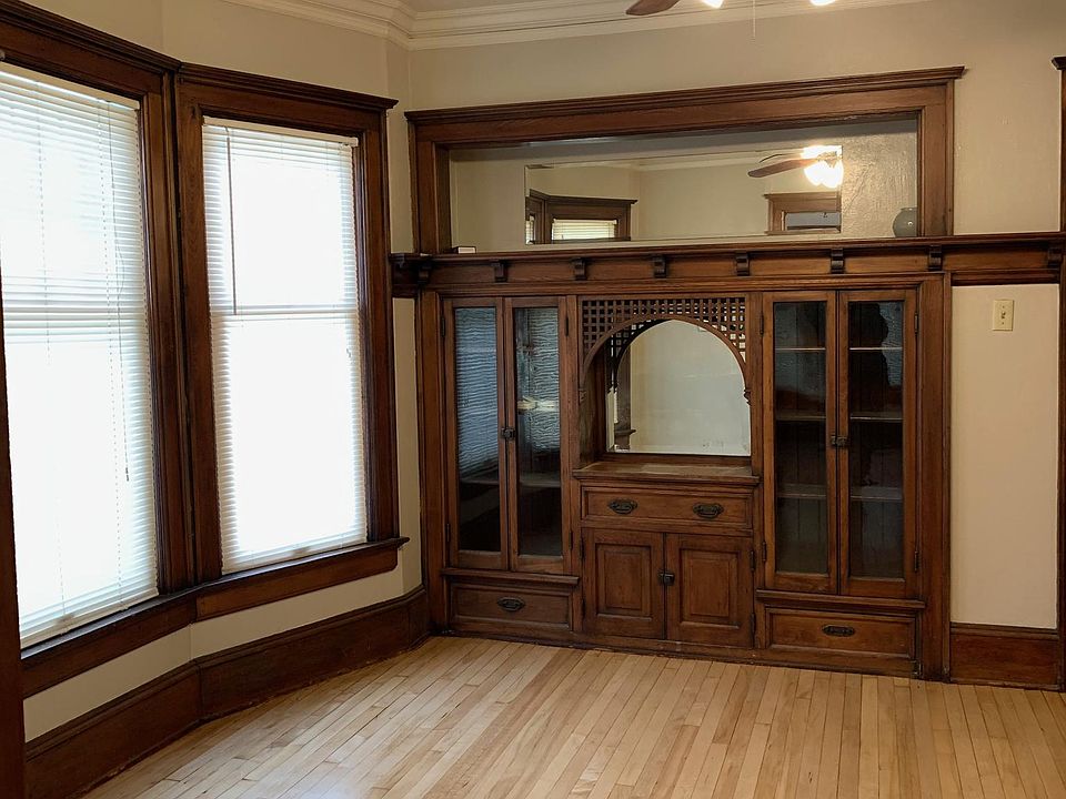 Dining room with built-in cabinet and maple hardwood floors.