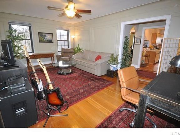 Large living room overlooking Garth Woods.  The room has a cove ceiling, picture molding, wall molding, baseboards and hardwood floors.  The room is 20'-4" x 13'-0".