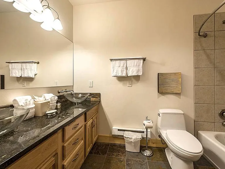 Bathroom #3 with his-and-hers sinks and shower/tub combo