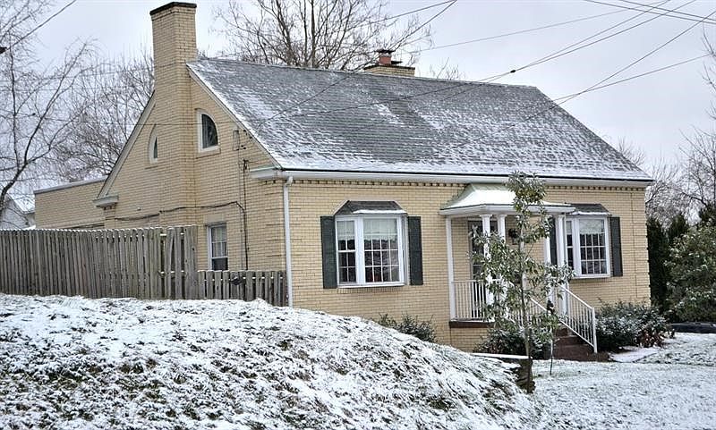 FRONT EXTERIOR. The house is located on a large corner lot in the award-winning Avonworth School District. Matching bay windows,
