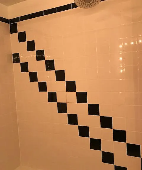 Bathtub enclosure black and white tile
