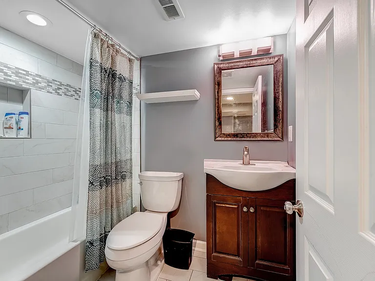 Second full bathroom in lower level complete with vanity, mirrored medicine chest, toilet, tub and shower