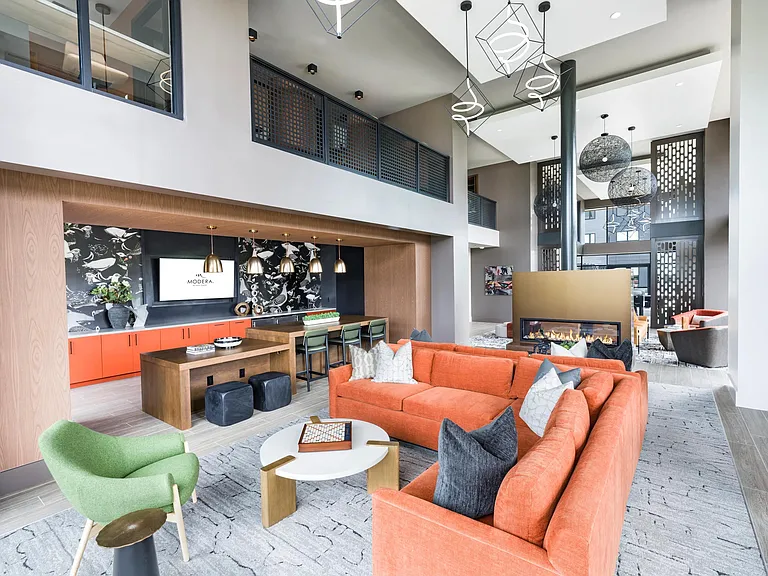 Vibrant resident lounge with a cozy fireplace, and versatile seating_perfect for hosting, relaxing, or connecting.