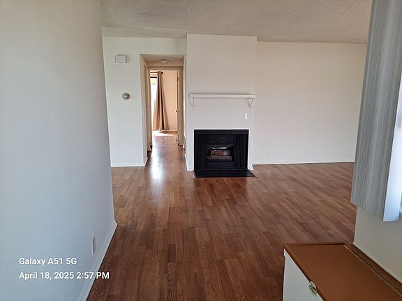 Entering the living room, you see the fireplace