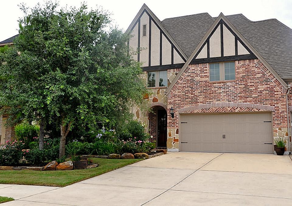 Lovely highland home with stone and brick exterior, 3 car garage, and lovely landscaping.