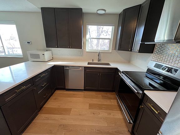 Quartz counters with Luxury Jennair dishwasher, fridge appliances