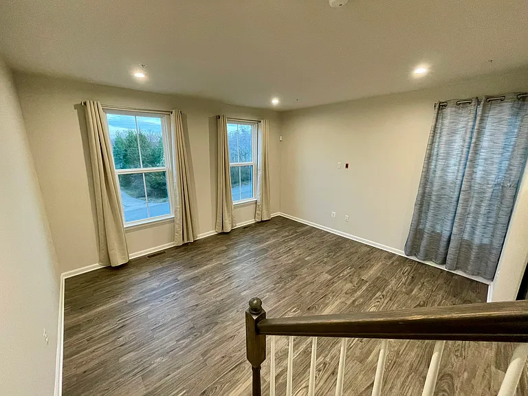Open living space with large windows and modern flooring