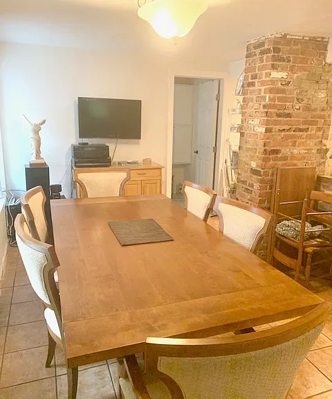 Large enough to hold a dining set with six chairs