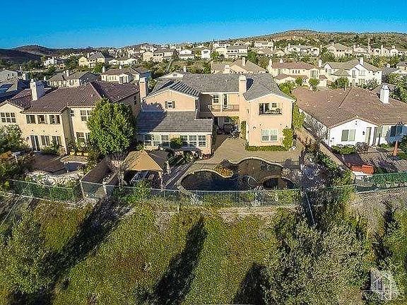 Aerial view of backyard with pool and spa