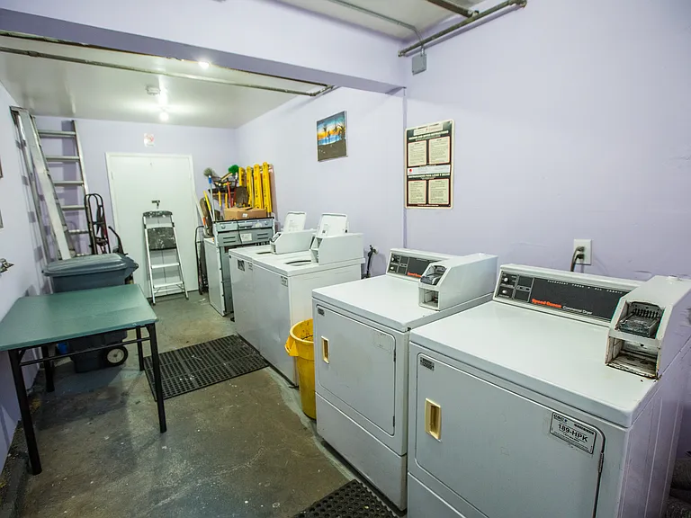 Laundry room by the entrance of the building.