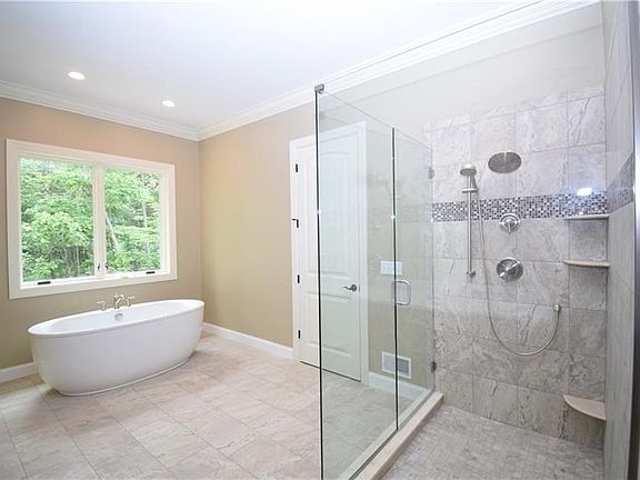 Master Bath has double bowl sink, tub, and separate tile shower.