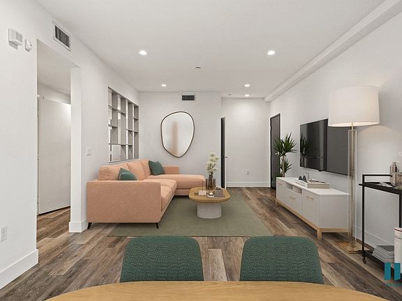 Open-Concept Dining and Living Room Space with Vinyl Flooring and Recessed Lighting