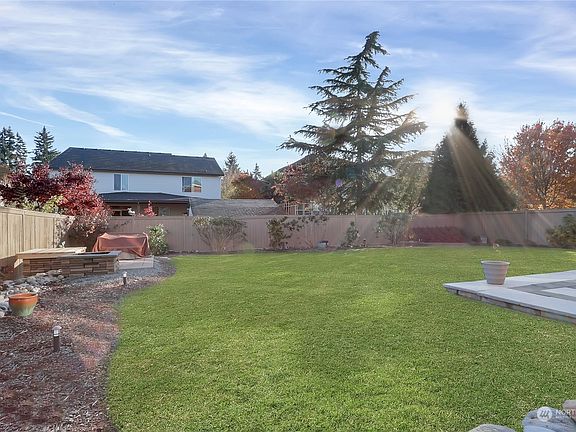 Large yard with fire pit and spectacular patio for year-round entertaining>