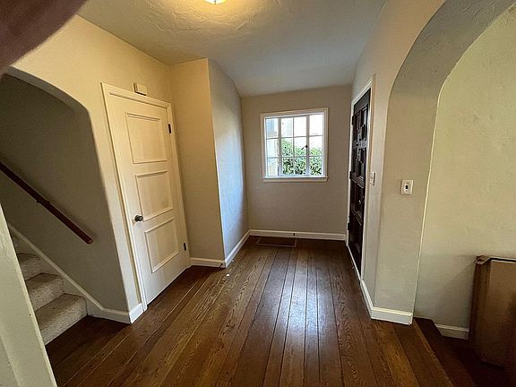 Formal entry and stairs leading upstairs to bedrooms