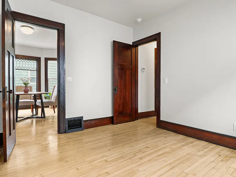 First bedroom looking into dining. Doorway to the right circles around to the kitchen and second bathroom. Circular desigs help air flow...