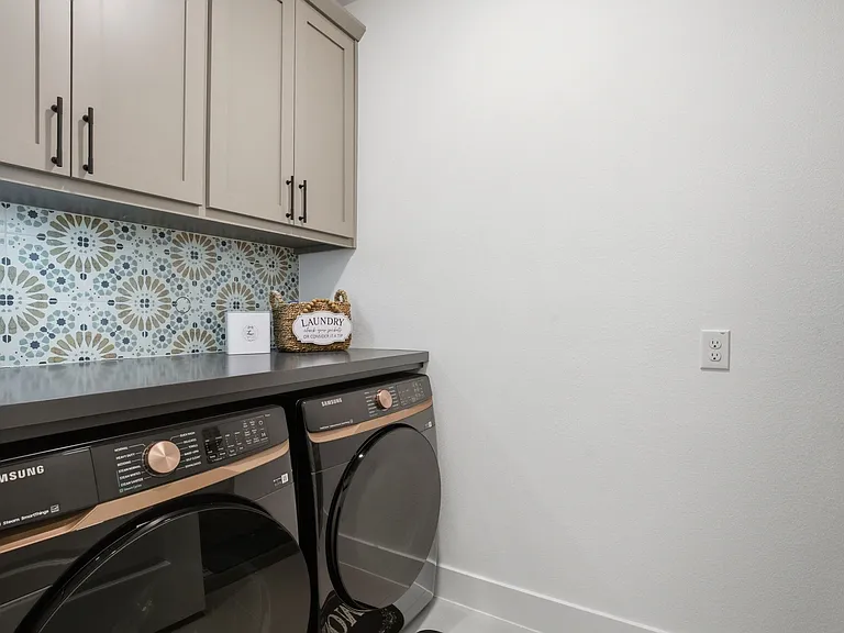 Yes...a cute utility room :) Love the accent tile above the folding counter space added by the owners + the handy storage cabinets....AND, to the right -- a custom designed pet bunk for your beloved pet to sleep or eat. Or use to store pool towels for the