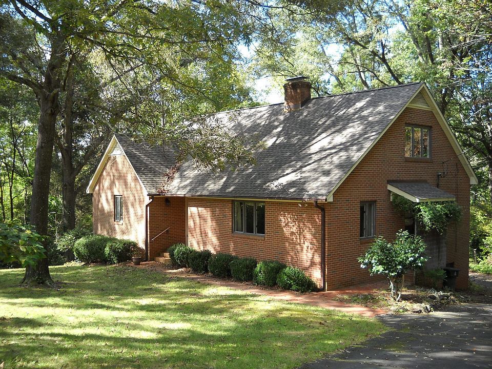 Nestled on a quiet cul-de-sac on 3.7 acres of wooded privacy