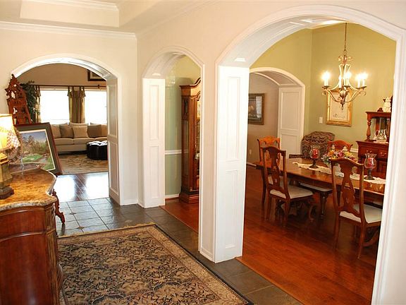 Entry with wood trimmed arches in to Dining Room and Family Room.