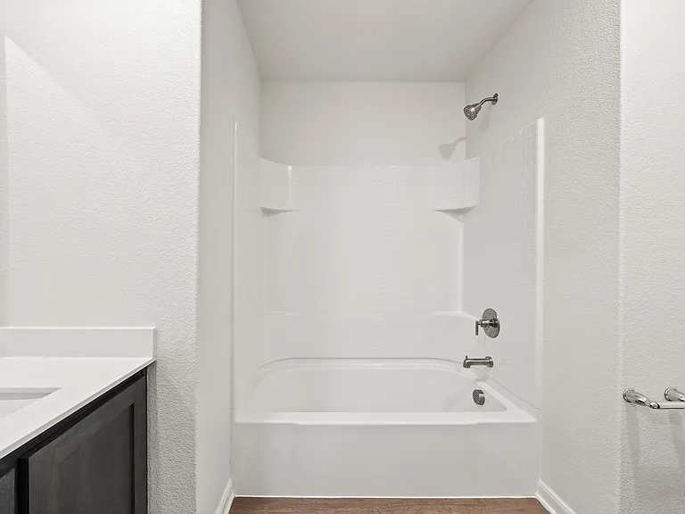 The secondary bathroom has a shower-tub combo.