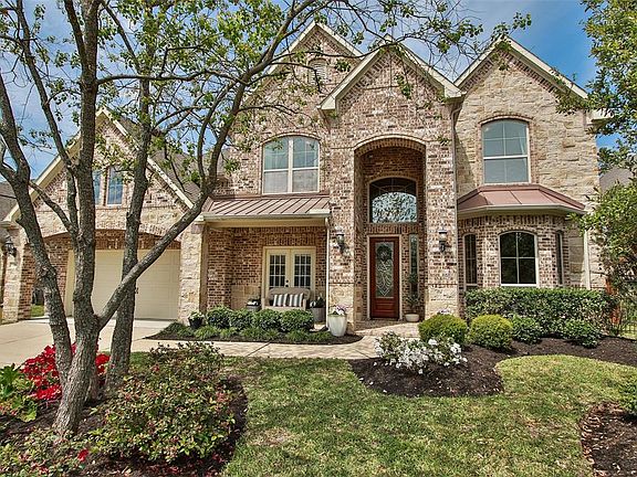 Elegant brick home with beautiful curb appeal and limestone accent.