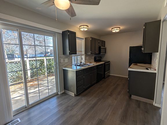 Kitchen and additional dining area. Sliding door accesses private patio.