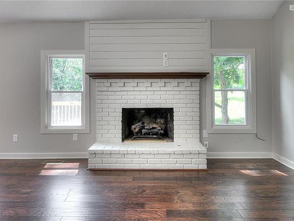 Updated fireplace flanked by windows