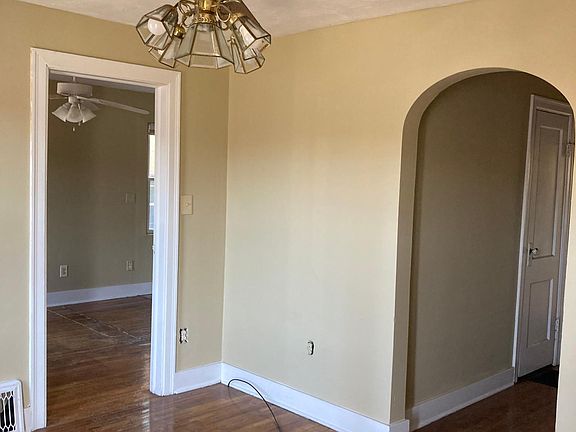 Living room leading to the main bedroom to the left and off to the right is the entry to the hallway towards the back room, hallway closet, basement and kitchen.