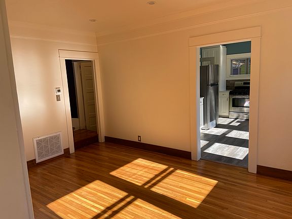 Living room. Door on left leads to bathroom and upstairs bedroom. Kitchen to the right.