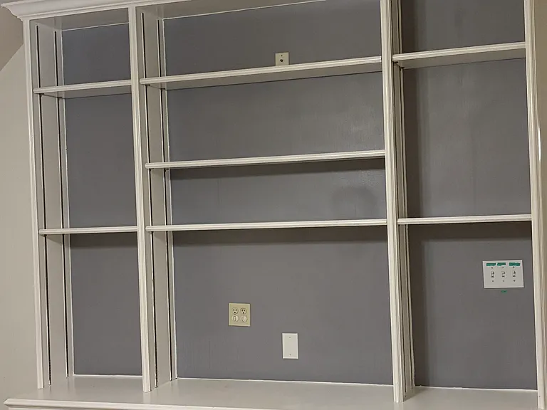 Game room's built-in entertainment center (empty shelves)