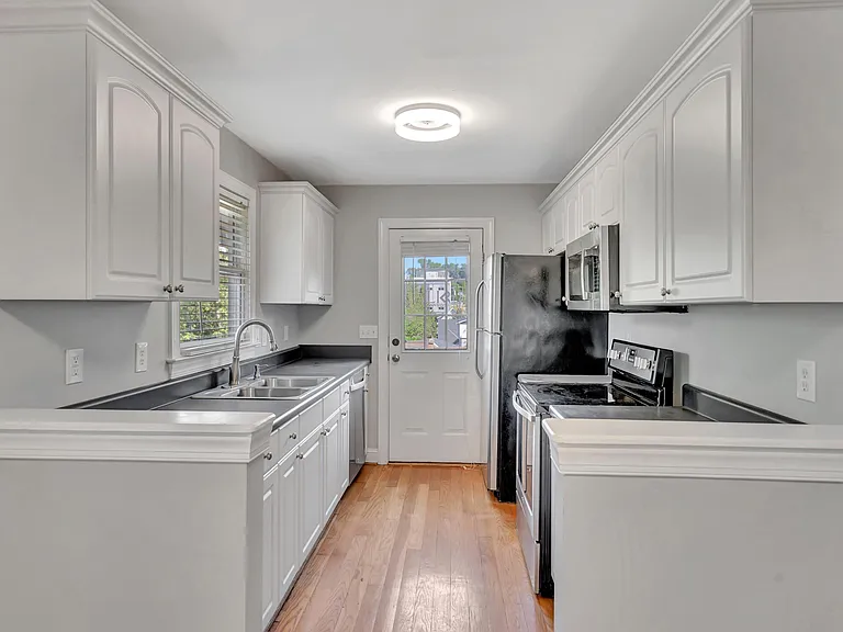 Fully equipped kitchen with everything you need: refrigerator, oven, microwave, cabinet space, cookware, dishes, utensils.