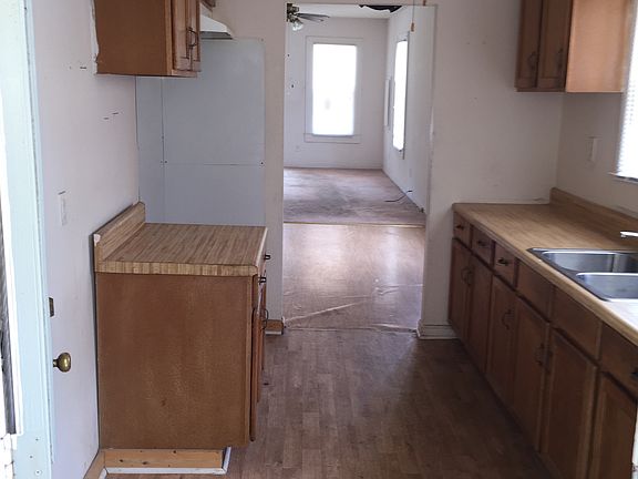 Looking from back door through kitchen, dining area, and liv