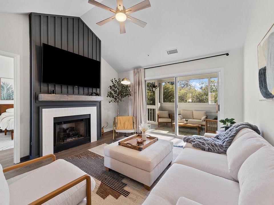 Welcome home! Vaulted ceilings with great natural light in this living room. Gas log fireplace.