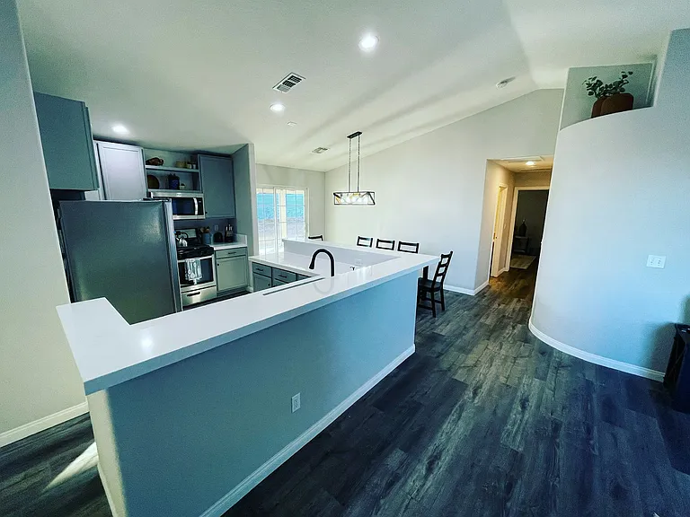 Open concept kitchen with sink facing the spacious living room!