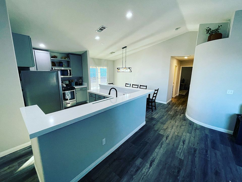 Open concept kitchen with sink facing the spacious living room!