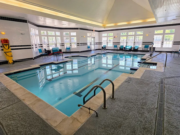 Luxurious, heated indoor swimming pool facility with expansive windows_enjoy swimming and low-impact exercise all year round.