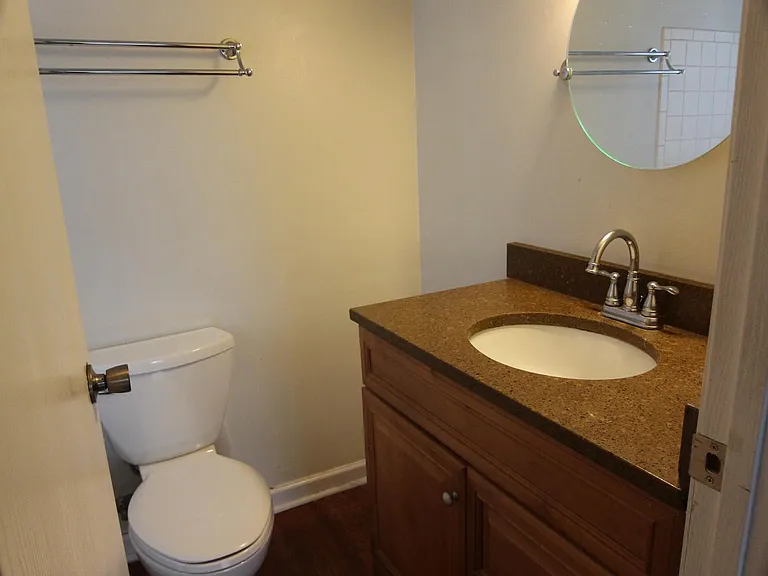 Bathroom with granite top and storage vanity.