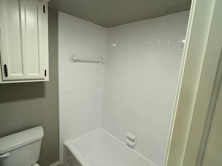 Master bath with newly glazed tub and tile.