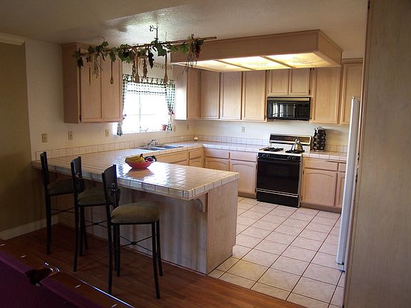 White Wash Cabinets, Tile Countertops and Breakfast Bar