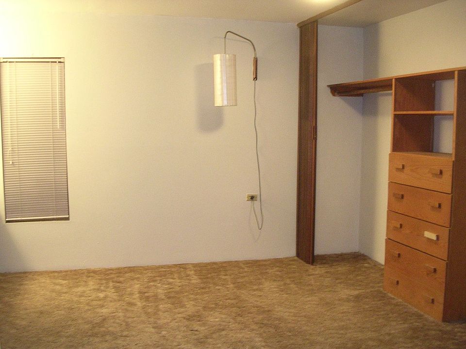 Bedroom has a very large 12 foot closet with built in chest of drawers in the middle. Hanging lamps on wall help to provide light without taking up usable space.