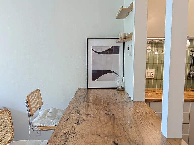 Kitchen-to-living-room pass-through with a solid elm wood counter.