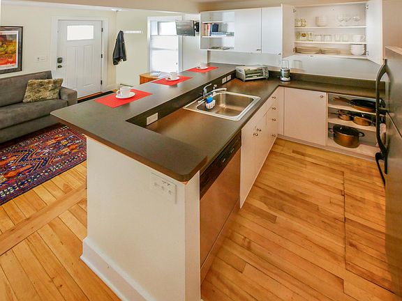 1st floor. Full kitchen with gas stove, fridge, microwave, dishwasher and plenty of cookware, dishes and utensils.