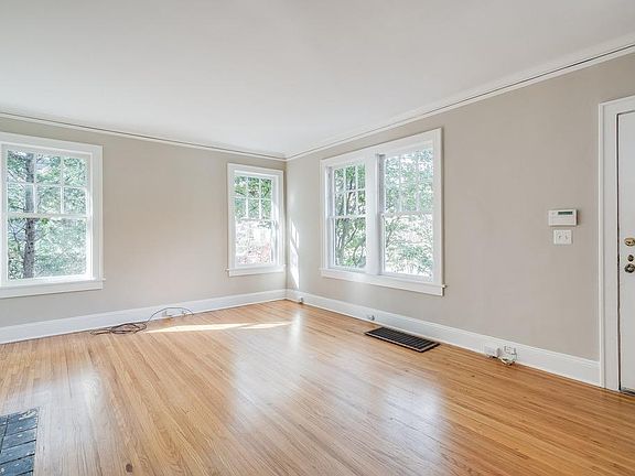 Large, bright living room with double doors to dining room