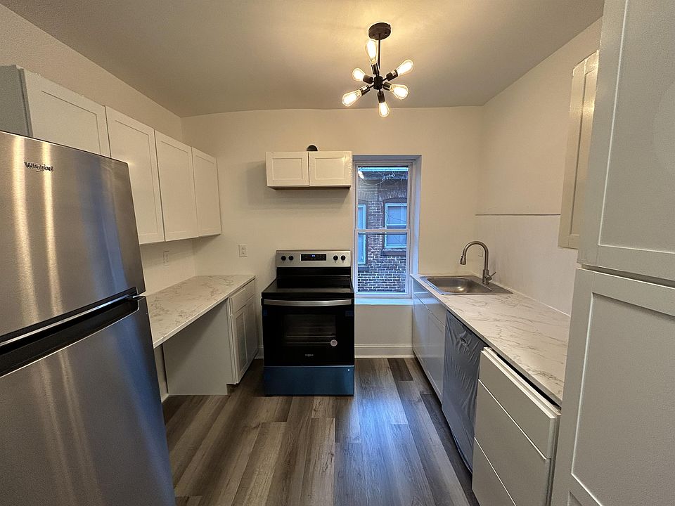 New modern kitchen with new stainless steel Oven , Microwave, Refrigerator, and dishwasher.